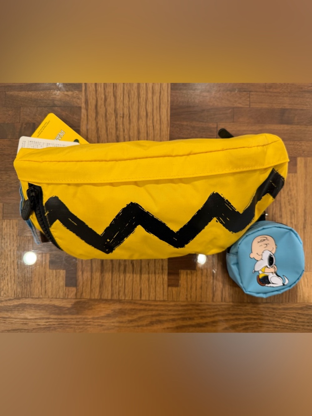 Lesportsac x Peanuts Crossbody Sling with Charlie Brown zig zag and Snoopy pouch